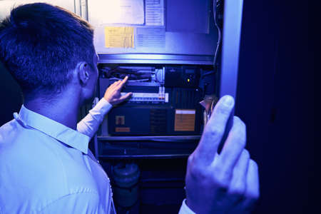 Technician monitoring power supply system on network server