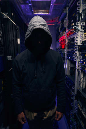 Data center intruder among racks with computer equipment