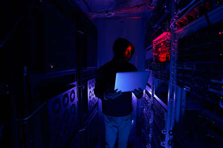 Hacker staring at data center network equipment