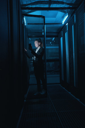 Photo of engineer businesswoman in network server room