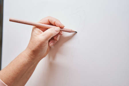 Female person standing near easel with canvasの写真素材