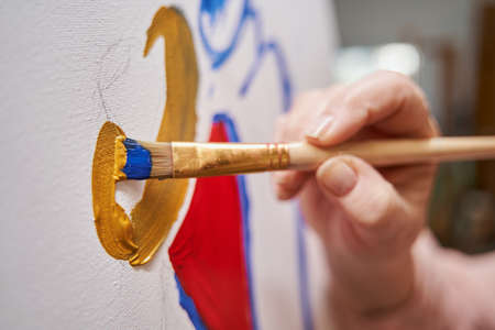 Focused photo on artist drawing abstract pictureの写真素材