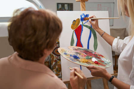 Focused photo on female hand drawing pictureの写真素材