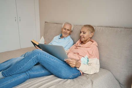 Cute senior female person watching video onlineの写真素材