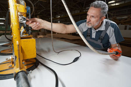 Close up of serious master using modern equipment