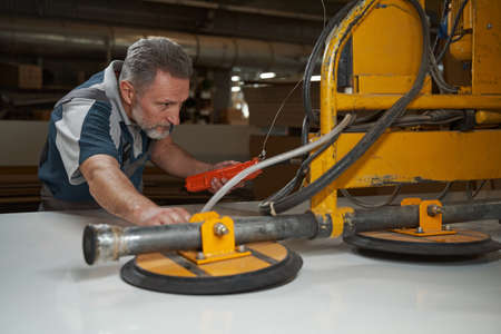 Focused photo on serious man testing professional equipment