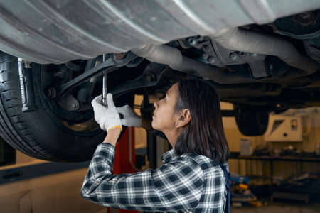 Enthusiastic mechanic examining the parts of the carの写真素材