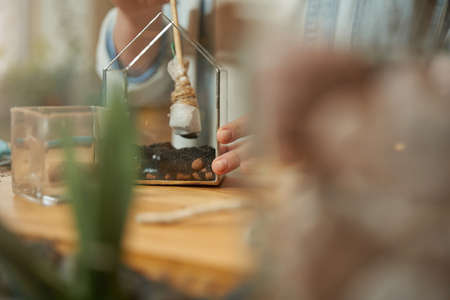 Woman working in studio and planting flowers