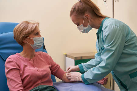 Attentive blonde woman looking at her practitioner
