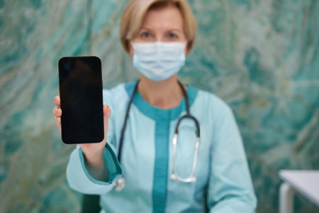 Focused photo on telephone being in female hand