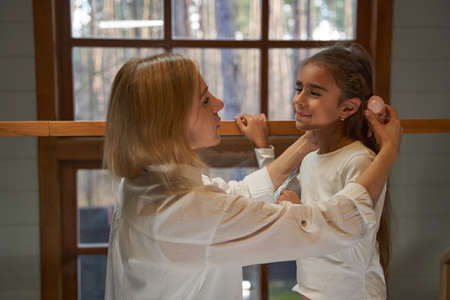 Charming brunette girl looking at her mother