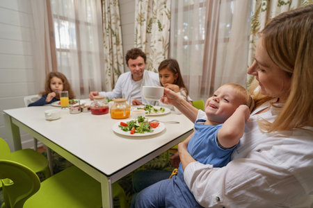 Close up of young woman playing with her kidの写真素材
