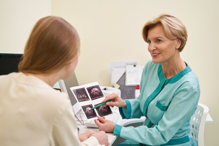 Delighted blonde doctor looking at her young visitor