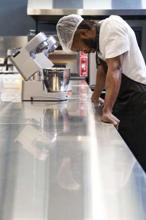 African male resting after work in the kitchenの写真素材