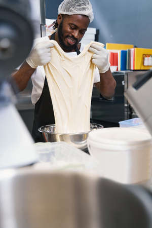 Male in protective clothes working at the kitchenの写真素材