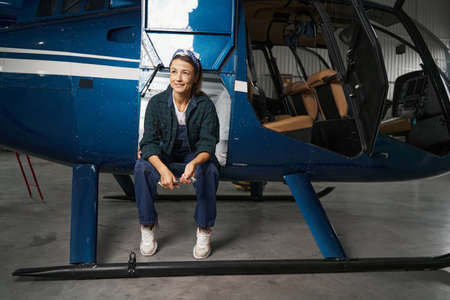 Brunette woman engineer resting during the break in hangarの写真素材
