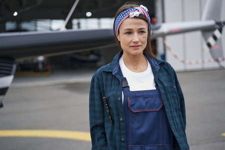 Elegant brunette female posing at the photo camera in the outdoorsの写真素材