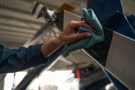 Unrecognized woman using special equipments while working in aviation garageの写真素材