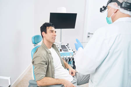 Medical worker in uniform and man at the hospital