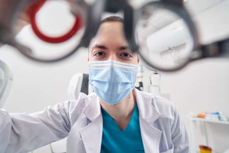 Professional ophthalmologist diagnosing the vision of patientの写真素材