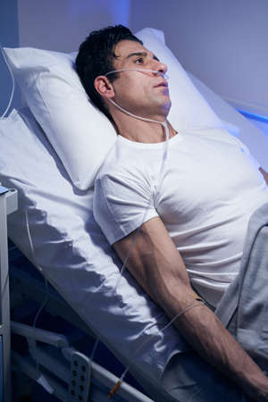 Close-up photo of man in white t-shirt restingの写真素材