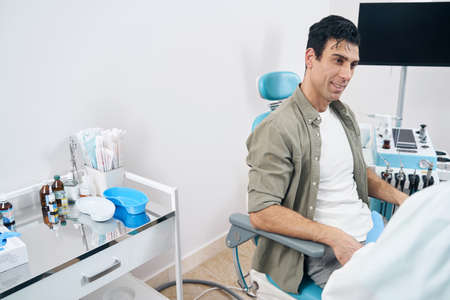Portrait of patient sitting in the otorhinolaryngologist officeの写真素材