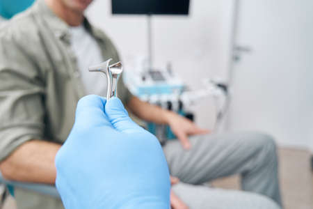 Close up of doctor hand holding nasal mirrorの写真素材