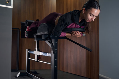 Cute brunette woman using professional simulator for legs
