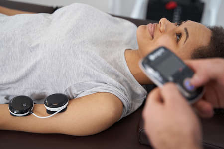 Physical rehabilitation with medical worker at gym