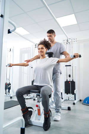 Female undergoing leg rehabilitation in the gym