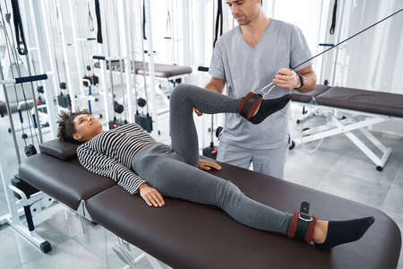 Young woman having rehabilitation in the gymの写真素材