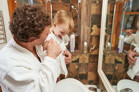 Portrait of dad and son at homeの写真素材