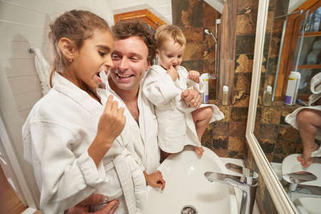 Portrait of happy dad and children at home