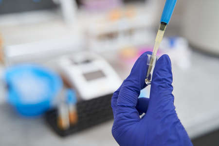 Nurse taking liquid for research in laboratory