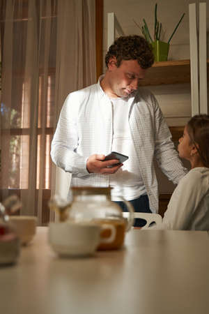 Dad talking to his daughter at homeの写真素材