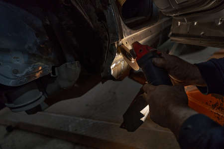 Man repairing car and working with toolの写真素材