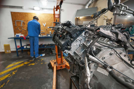 Mechanic working near the table in the garage