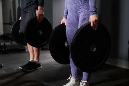 Female exercising in the fitness club with coachの写真素材