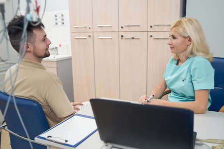 Young man visiting female practitioner in modern office