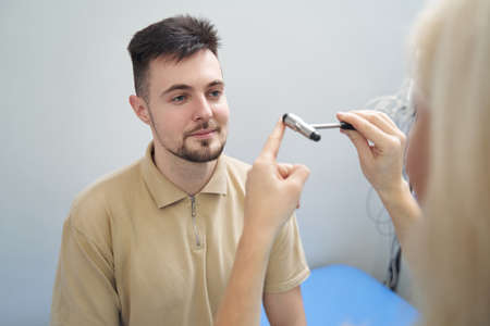 Young calm man during check-up at neurologist