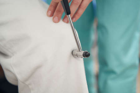 Neurologist doing examination for male patient in officeの写真素材