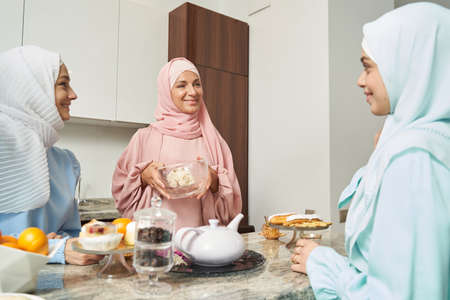 Young Muslim women cooking desserts at homeの写真素材