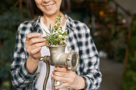 Adult female holding original design flower potの写真素材