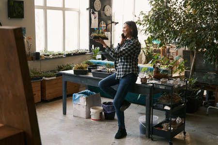 Lady working in studio and talking with clients