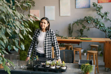Portrait of woman looking at camera in studioの写真素材