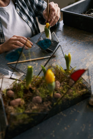 Close-up photo of florist working in studio