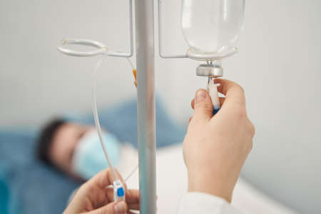 Ill man being treated in hospital by doctorの写真素材