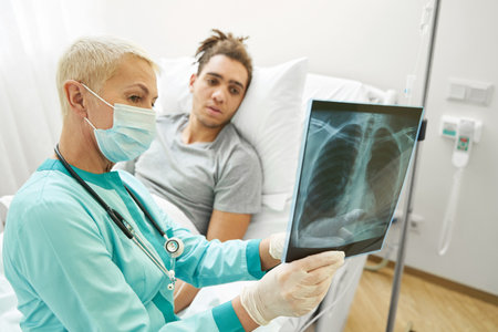 Medical professional talking to patient about x-rayの写真素材