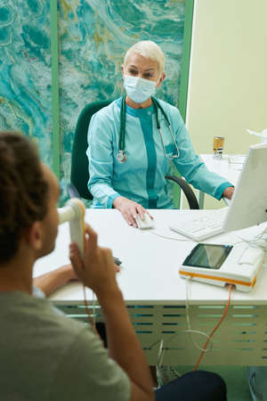 Doctor looking at patient, passing spirometry test