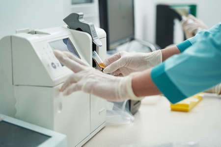 Female laborant doing blood tests with modern equipmentの写真素材